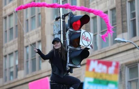 Nicoletta Longo waved a boa on top of a traffic light in Boston on Satuday.
